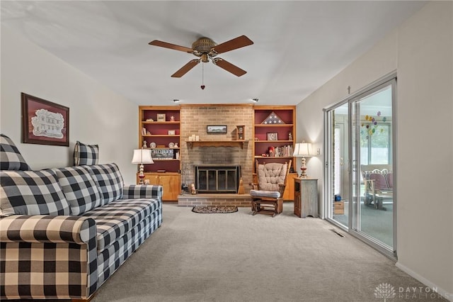 6719 Morrow Dr, Clayton, OH 45415 - living room featuring ceiling fan, carpet floors, built in shelves, and a fireplace