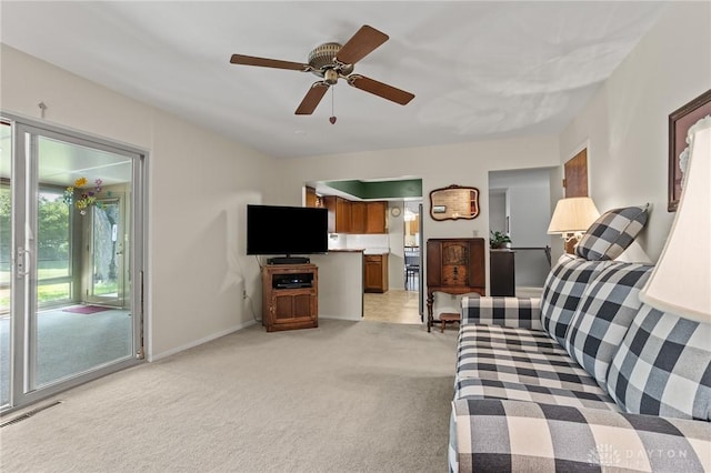 6719 Morrow Dr, Clayton, OH 45415 - living area with light colored carpet, a ceiling fan, and baseboards