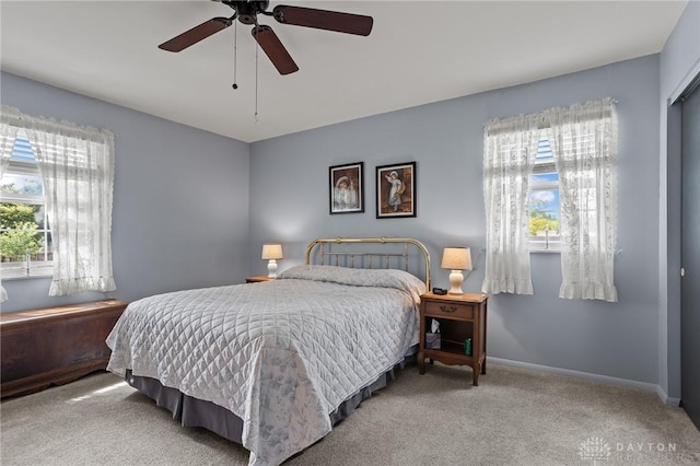 6719 Morrow Dr, Clayton, OH 45415 - carpeted bedroom with multiple windows, baseboards, and a ceiling fan