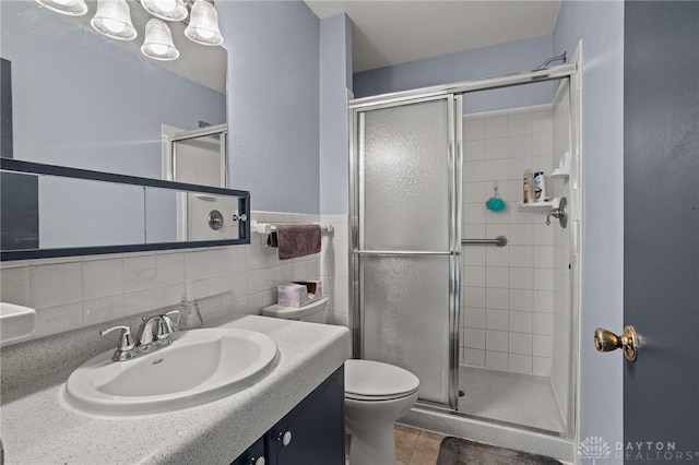 6719 Morrow Dr, Clayton, OH 45415 - bathroom featuring a stall shower, vanity, toilet, and tile patterned flooring