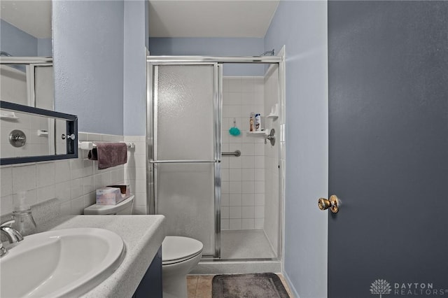 6719 Morrow Dr, Clayton, OH 45415 - bathroom with a stall shower, toilet, vanity, tile patterned flooring, and tile walls