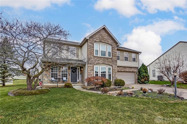 1061 Dapple Ct, Fairborn, OH 45324 - traditional-style house featuring stone siding, a garage, concrete driveway, and a front lawn