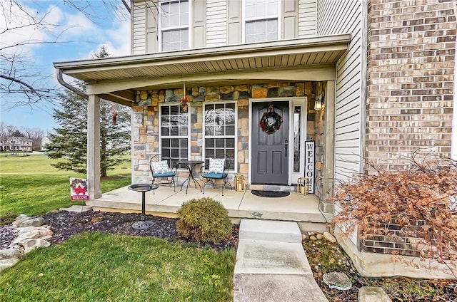 1061 Dapple Ct, Fairborn, OH 45324 - view of exterior entry with covered porch and a yard