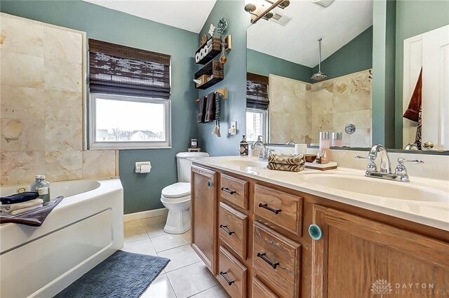 1061 Dapple Ct, Fairborn, OH 45324 - full bathroom featuring a garden tub, lofted ceiling, double vanity, tile patterned flooring, and toilet