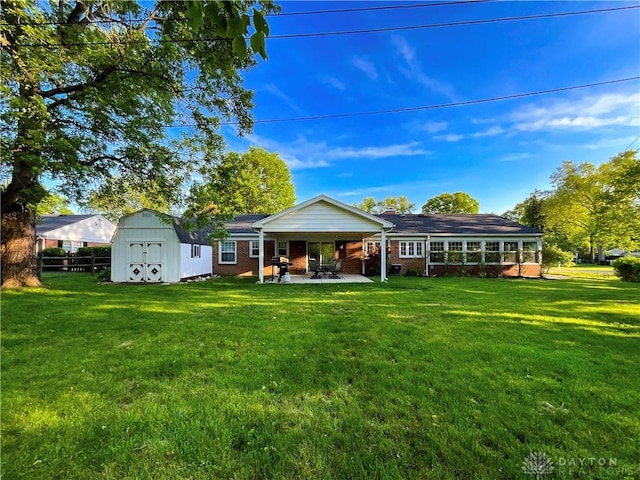 869 Maxwelton, Washington Twp, OH 45459 - rear view of property featuring a lawn, a patio, and brick siding