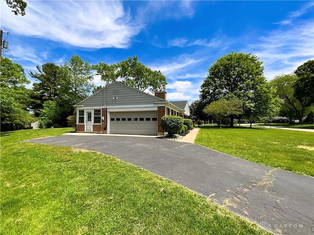 869 Maxwelton, Washington Twp, OH 45459 - view of front facade featuring brick siding, an attached garage, a front lawn, driveway, and a chimney