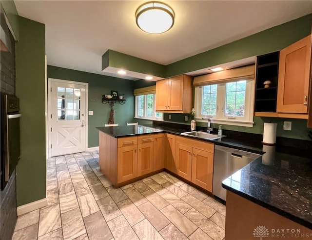 869 Maxwelton, Washington Twp, OH 45459 - kitchen with stainless steel dishwasher, a sink, a peninsula, black oven, and baseboards