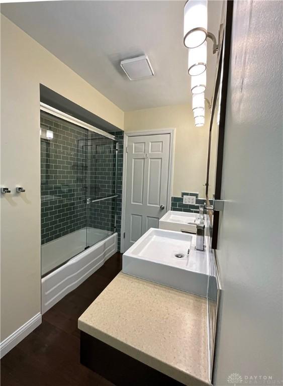 869 Maxwelton, Washington Twp, OH 45459 - full bath featuring shower / bath combination with glass door, double vanity, and wood finished floors