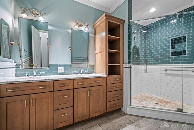 325 Bending Branch Ln, Miamisburg, OH 45342 - full bathroom featuring ornamental molding, a shower stall, double vanity, and tasteful backsplash
