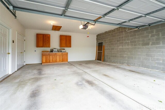 325 Bending Branch Ln, Miamisburg, OH 45342 - garage with a garage door opener and concrete block wall