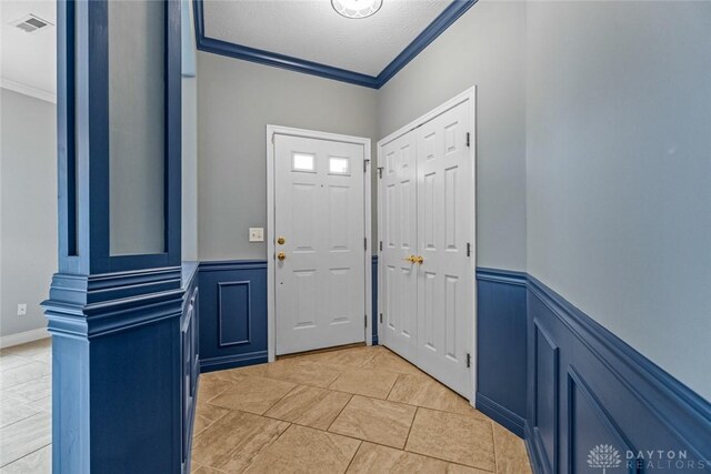 325 Bending Branch Ln, Miamisburg, OH 45342 - foyer entrance featuring ornamental molding, wainscoting, and a decorative wall