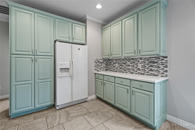 325 Bending Branch Ln, Miamisburg, OH 45342 - kitchen with white refrigerator with ice dispenser, green cabinets, crown molding, light countertops, and baseboards