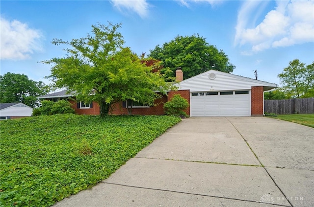 6123 Millbrook Dr, Washington Twp, OH 45459 - single story home featuring brick siding, a chimney, and a detached garage
