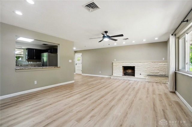 6123 Millbrook Dr, Washington Twp, OH 45459 - unfurnished living room with a ceiling fan, light wood-style flooring, recessed lighting, a fireplace, and baseboards