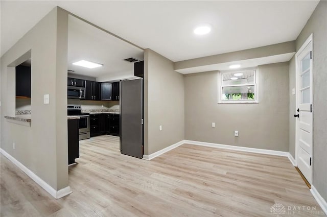 6123 Millbrook Dr, Washington Twp, OH 45459 - kitchen with appliances with stainless steel finishes, dark cabinetry, light wood-style floors, light countertops, and baseboards