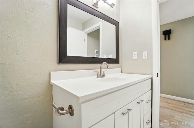 6123 Millbrook Dr, Washington Twp, OH 45459 - bathroom with vanity, wood finished floors, and baseboards