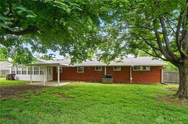 6123 Millbrook Dr, Washington Twp, OH 45459 - rear view of house featuring a sunroom, brick siding, and a patio area