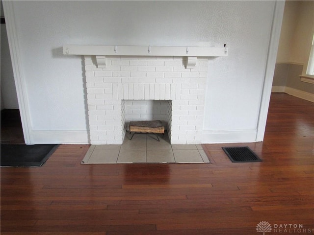 2455 Catalpa Dr, Dayton, OH 45406 - detailed view of wood finished floors, baseboards, and a fireplace