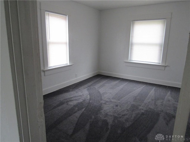 2455 Catalpa Dr, Dayton, OH 45406 - unfurnished room featuring dark carpet, healthy amount of natural light, and baseboards