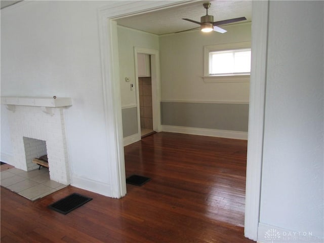 2455 Catalpa Dr, Dayton, OH 45406 - unfurnished living room with hardwood / wood-style floors, baseboards, a ceiling fan, and a brick fireplace