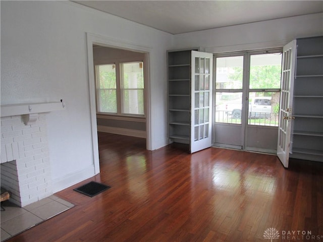 2455 Catalpa Dr, Dayton, OH 45406 - unfurnished living room with wood finished floors, plenty of natural light, and baseboards