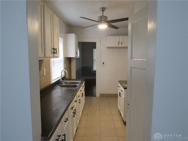 2455 Catalpa Dr, Dayton, OH 45406 - kitchen with a sink, dark countertops, ceiling fan, and white cabinets