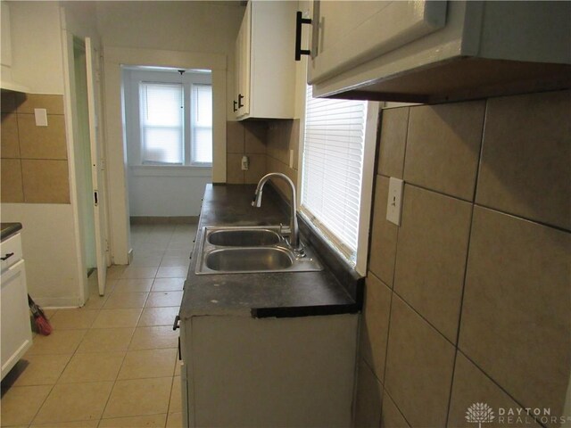 2455 Catalpa Dr, Dayton, OH 45406 - kitchen featuring a sink, dark countertops, white cabinetry, and light tile patterned floors