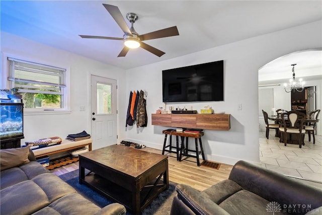 2819 Mccall St, Dayton, OH 45417 - living area with a chandelier, arched walkways, a ceiling fan, and baseboards