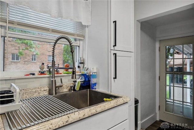 2819 Mccall St, Dayton, OH 45417 - kitchen with a sink, white cabinetry, light stone countertops, and dark wood-style floors