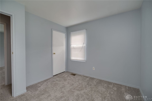 1115 Richard Dr, Xenia, OH 45385 - unfurnished bedroom featuring light colored carpet and baseboards