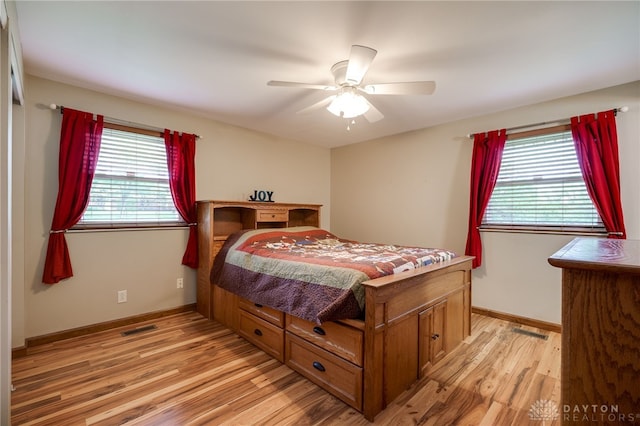 1252 Harmony Ln, Fairborn, OH 45324 - bedroom featuring multiple windows, light wood-type flooring, and baseboards