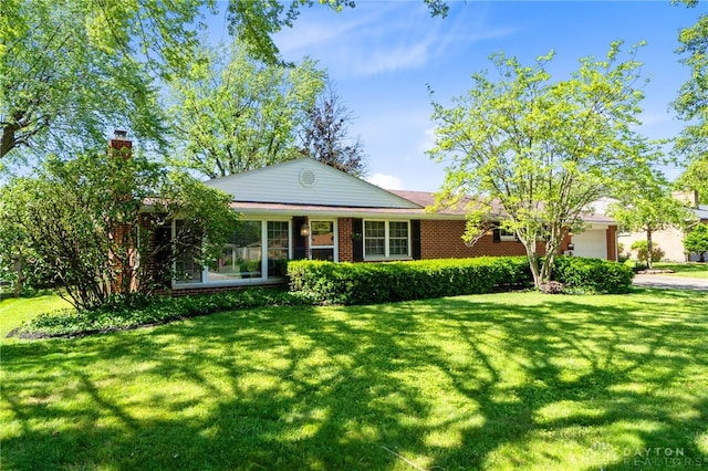 1108 Donson Dr, Kettering, OH 45429 - ranch-style home featuring a front lawn, a garage, a chimney, and brick siding