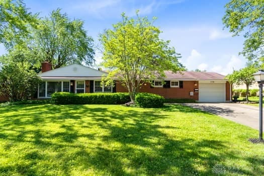 1108 Donson Dr, Kettering, OH 45429 - ranch-style home featuring a garage, a front lawn, driveway, and a chimney