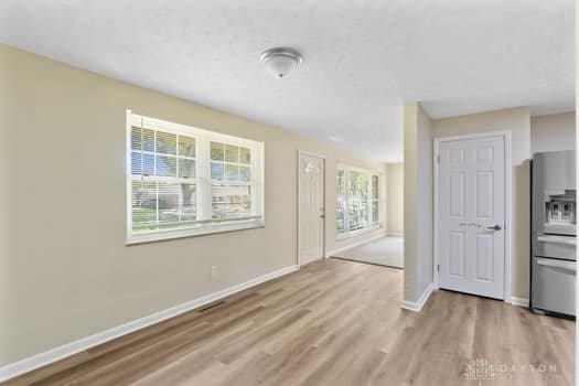 1108 Donson Dr, Kettering, OH 45429 - unfurnished living room featuring wood finished floors and baseboards