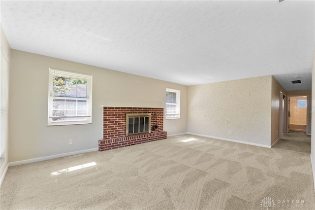 1108 Donson Dr, Kettering, OH 45429 - unfurnished living room featuring carpet flooring, baseboards, a textured ceiling, and a fireplace