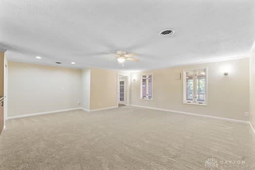 1108 Donson Dr, Kettering, OH 45429 - empty room featuring ceiling fan, light carpet, and baseboards