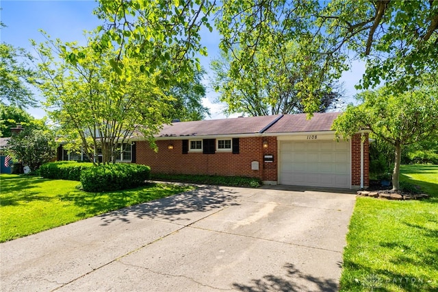 1108 Donson Dr, Kettering, OH 45429 - view of front of property featuring a garage, a front yard, brick siding, and concrete driveway