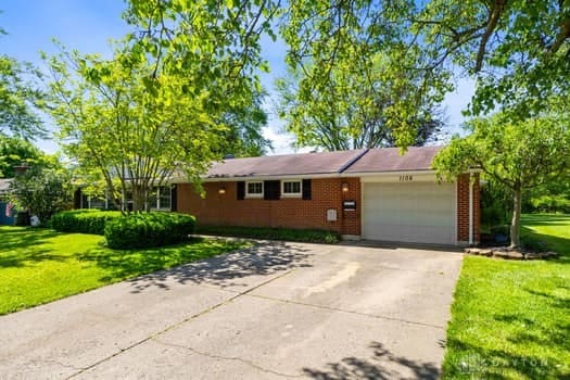 1108 Donson Dr, Kettering, OH 45429 - single story home with an attached garage, a front lawn, concrete driveway, and brick siding