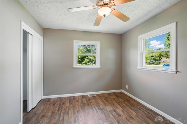 6726 Middletown Germantown Rd, Middletown, OH 45042 - unfurnished bedroom with dark wood-style flooring, baseboards, a closet, a ceiling fan, and a textured ceiling