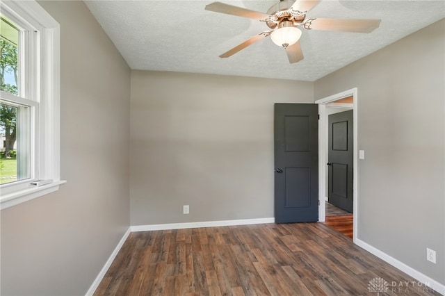 6726 Middletown Germantown Rd, Middletown, OH 45042 - spare room featuring dark wood-style floors, baseboards, a textured ceiling, and ceiling fan