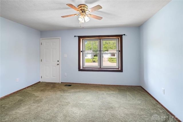 1385 Kylemore Dr, Xenia, OH 45385 - spare room with carpet, ceiling fan, baseboards, and a textured ceiling