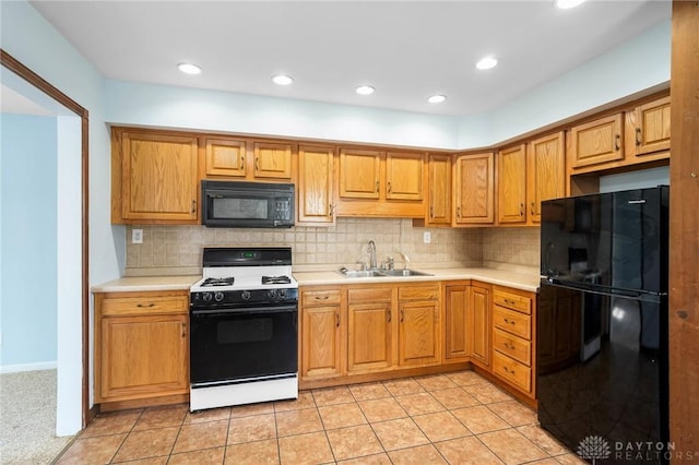 1385 Kylemore Dr, Xenia, OH 45385 - kitchen with black appliances, a sink, light countertops, backsplash, and recessed lighting
