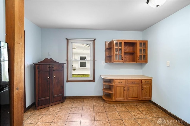 1385 Kylemore Dr, Xenia, OH 45385 - kitchen with open shelves, baseboards, glass insert cabinets, and light countertops