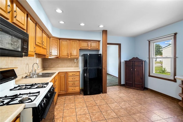 1385 Kylemore Dr, Xenia, OH 45385 - kitchen featuring black appliances, light countertops, tasteful backsplash, a sink, and recessed lighting