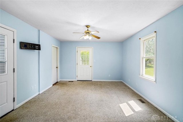 1385 Kylemore Dr, Xenia, OH 45385 - empty room featuring carpet floors, ceiling fan, and baseboards