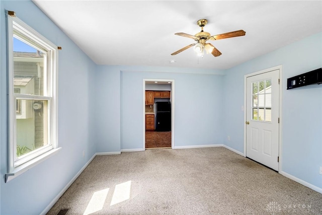 1385 Kylemore Dr, Xenia, OH 45385 - carpeted empty room featuring baseboards and a ceiling fan