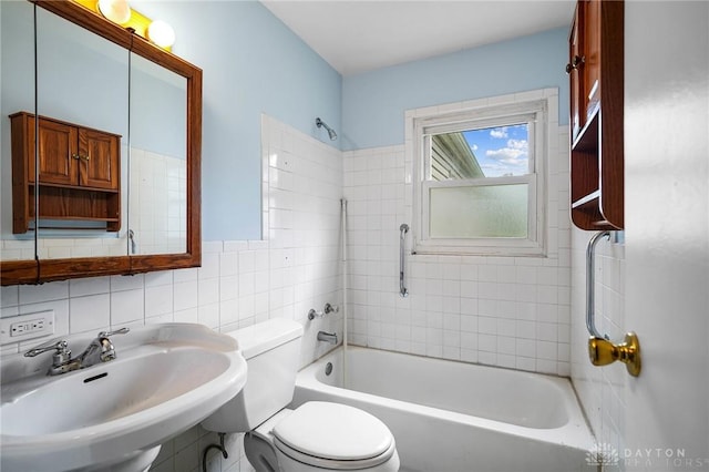 1385 Kylemore Dr, Xenia, OH 45385 - bathroom with a sink, toilet, bathtub / shower combination, and tile walls