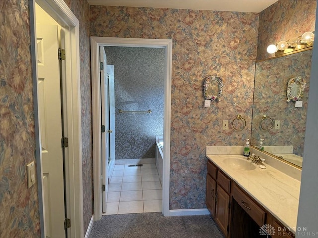 70 Pond Run Cir, Hamilton, OH 45013 - bathroom featuring vanity, baseboards, a tub to relax in, wallpapered walls, and tile patterned flooring