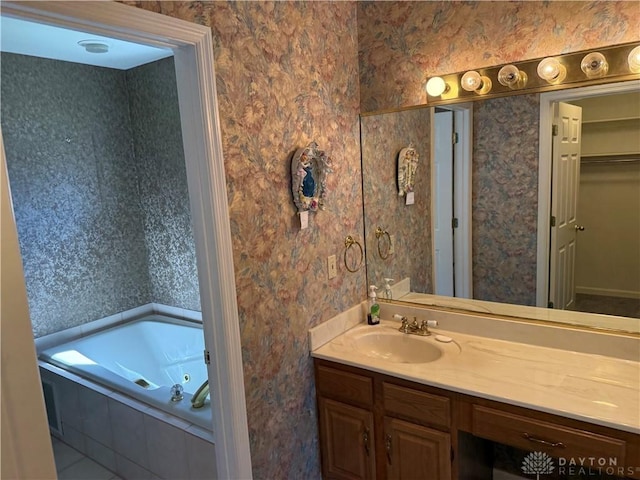 70 Pond Run Cir, Hamilton, OH 45013 - bathroom with wallpapered walls, vanity, and a tub with jets