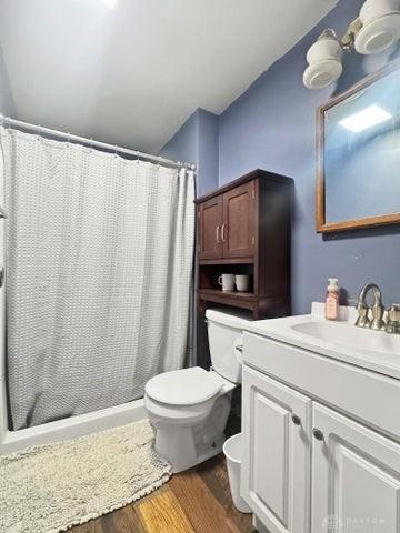 1277 Yocom Rd, Cable, OH 43009 - full bathroom with toilet, wood finished floors, vanity, and a shower with curtain